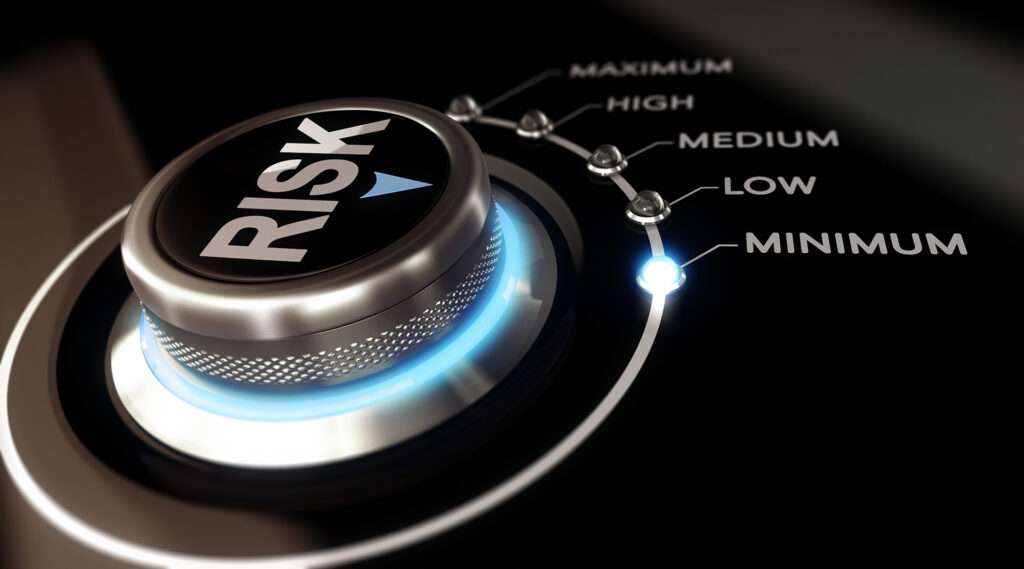 Switch button positioned on the word minimum, black background and blue light. Conceptual image for illustration of Risk management or assessment.